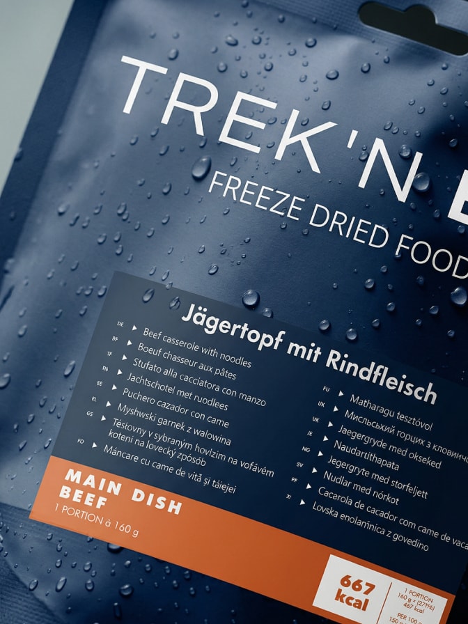Selection of Trek 'n Eat meal varieties laid out on a wooden surface